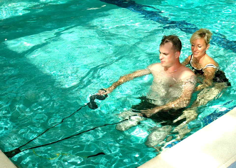 US Navy 091001-N-6326B-090 Lyn A. Boulanger, a Naval Medical Center San Diego occupational therapist, assists Marine Corps Staff Sgt. Jesse A. Cottle, a bilateral amputee, while he practices swimming during endurance training