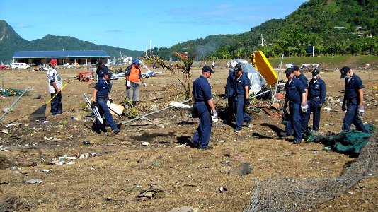 US Navy 091001-N-0000X-002 Sailors assigned to the guided-missile frigate USS Ingraham (FFG 61) clear away debris during disaster recovery efforts in Pago Pago, American Samoa