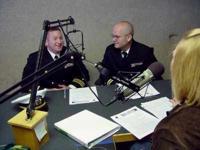 US Navy 091002-N-2888Q-002 Lt. Cmdr. Damon Slutz, commanding officer of Navy Operation Support Center Albuquerque, left, and Lt. Kris Hooper, assigned to the Navy Office of Community Outreach, conduct a radio interview with Amy
