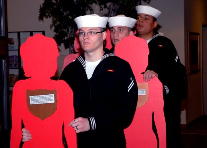 US Navy 091001-N-4649C-001 Sailors assigned to Trident Training Facility at Naval Base Kitsap present silent witness silhouettes during a candlelight vigil at the Jackson Park chapel. The silent witness silhouettes represent vi