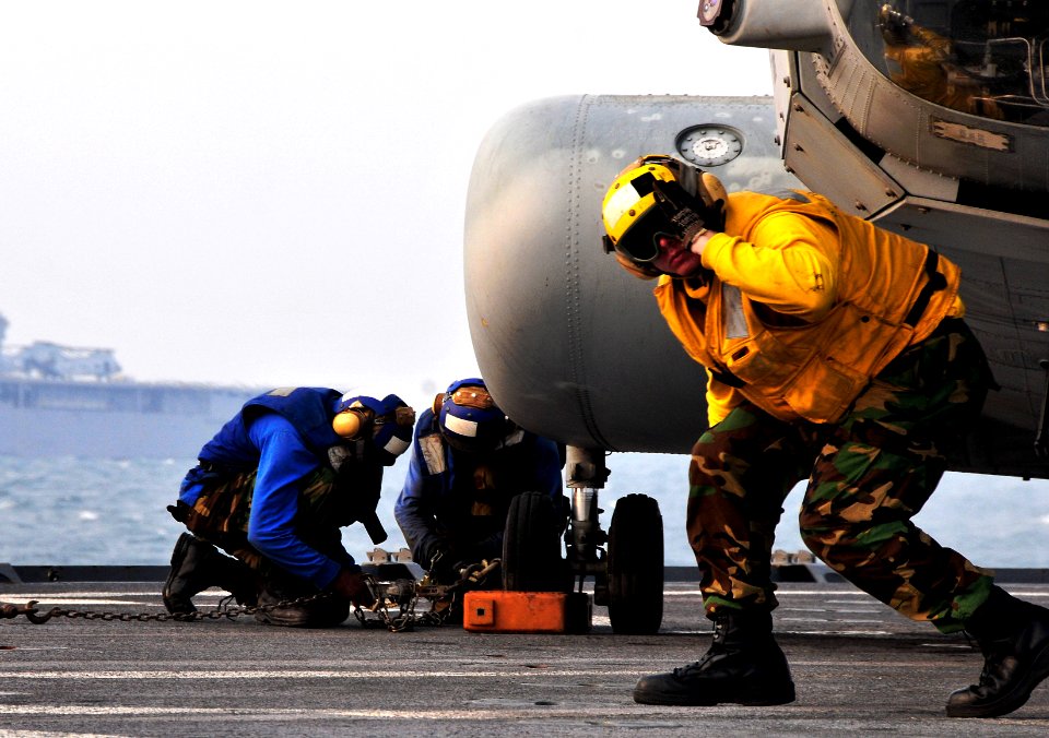 US Navy 091006-N-0807W-690 Sailors aboard the amphibious dock landing ship USS Harpers Ferry (LSD 49) secure a U.S. Marine Corps CH-46 Sea Knight helicopter during flight operations