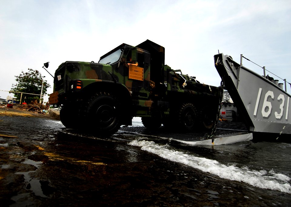 US Navy 091005-N-0807W-476 A U.S. Marine Corps 7-ton truck rolls off Landing Craft Utility 1631, assigned to the amphibious dock landing ship USS Harpers Ferry (LSD 49), during an equipment and supply offload