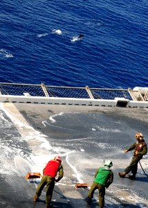 US Navy 091002-N-3165S-231 Marines from Marine Medium Tiltrotor Squadron (VMM) 263 (Reinforced), 22nd Marine Expeditionary Unit (22nd MEU), scrub the flight deck of the multi-purpose amphibious assault ship USS Bataan (LHD 5) w photo