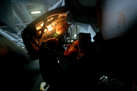 US Navy 091003-N-8960W-061 Aviation Structural Mechanic 2nd Class Anthony Ward performs maintenance on an EA-6B Prowler assigned to the Black Ravens of Electronic Attack Squadron (VAQ) 135 in the hangar bay of the aircraft carr