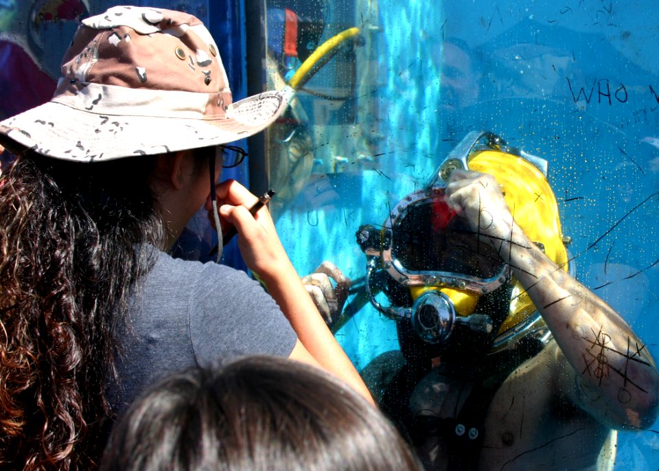 US Navy 091003-N-5191L-056 U.S. Navy Diver 2nd Class Matthew Cortez assigned to Navy Southwest Regional Maintenance Center plays tic tac toe with spectators attending the Marine Corps Air Station Miramar air show