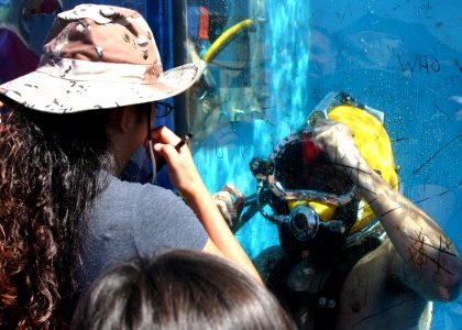 US Navy 091003-N-5191L-056 U.S. Navy Diver 2nd Class Matthew Cortez assigned to Navy Southwest Regional Maintenance Center plays tic tac toe with spectators attending the Marine Corps Air Station Miramar air show