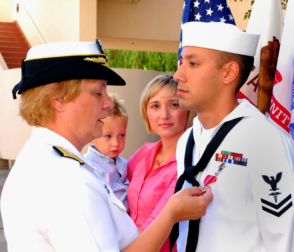 US Navy 091002-N-6326B-010 Rear Adm. Christine M. Bruzek-Kohler, commander of Naval Medical Center San Diego, presents the Bronze Star medal to Hospital Corpsman 2nd Class Phillip A. Azevedo