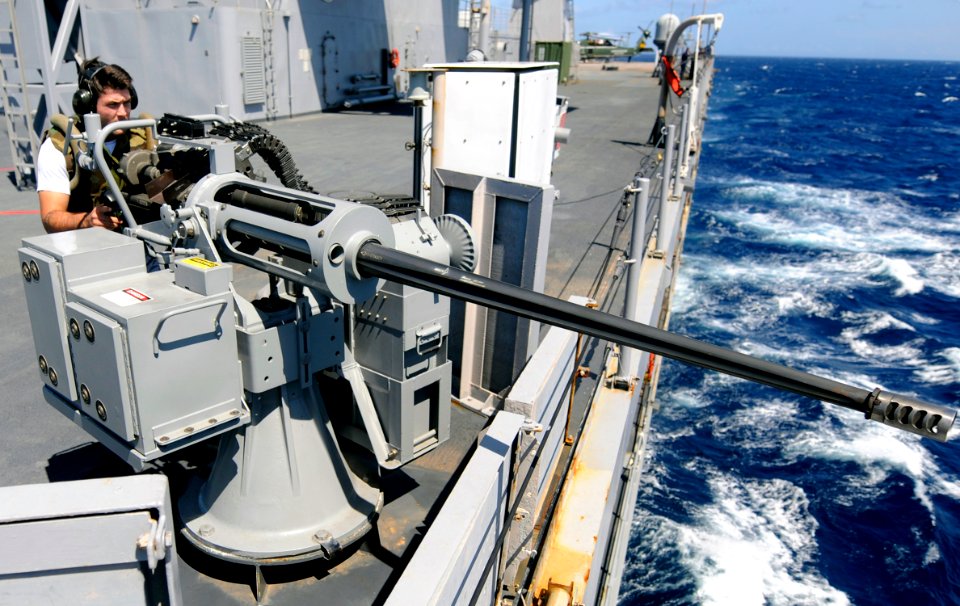 US Navy 091007-N-7280V-159 Gunner's Mate 3rd Class James Wilkerson mans a 25-mm machine gun during a combat systems training team environment aboard the amphibious command ship USS Blue Ridge (LCC 19)