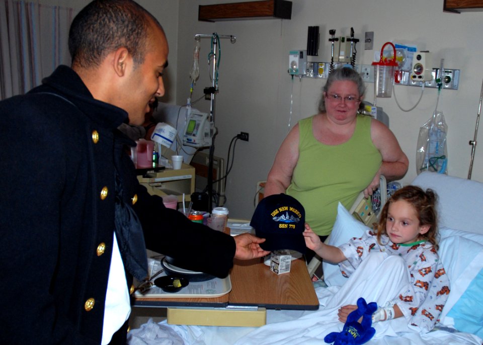 US Navy 091005-N-2893B-001 Seaman Miguel Arias, assigned to USS Constitution, gives a Navy ball cap to a patient at the Albuquerque Presbyterian Hospital during an Albuquerque Navy Week