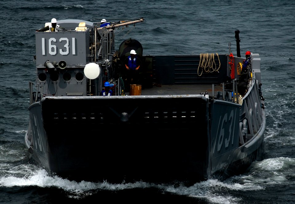 US Navy 091005-N-0807W-207 Landing Craft Utility 1631, assigned to Assault Craft Unit (ACU) 5, approaches the amphibious dock landing ship USS Harpers Ferry (LSD 49) during an equipment and supply offload
