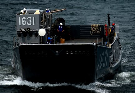 US Navy 091005-N-0807W-207 Landing Craft Utility 1631, assigned to Assault Craft Unit (ACU) 5, approaches the amphibious dock landing ship USS Harpers Ferry (LSD 49) during an equipment and supply offload