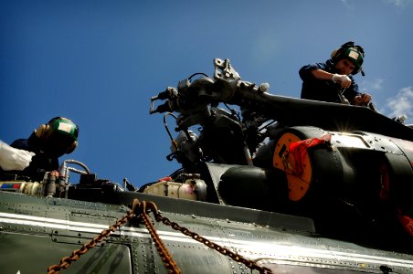 US Navy 091006-N-3830J-006 Aviation Structural Mechanic 2nd Class Jocelyn Joseph and Aviation Machinist's Mate 2nd Class Steven Cruz conduct maintenance on an SH-60F Sea Hawk helicopter