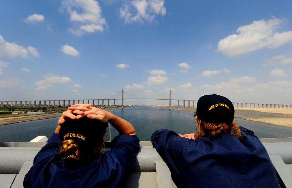 US Navy 091007-N-5345W-121 Ensigns Amee Johnson, left, and Judith Bates watch from the starboard bridge wing as the amphibious dock landing ship USS Fort McHenry (LSD 43) approaches the Egyptian-Japanese Friendship Bridge at El