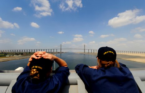 US Navy 091007-N-5345W-121 Ensigns Amee Johnson, left, and Judith Bates watch from the starboard bridge wing as the amphibious dock landing ship USS Fort McHenry (LSD 43) approaches the Egyptian-Japanese Friendship Bridge at El