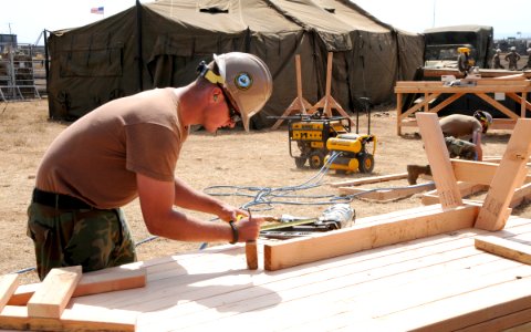 US Navy 091008-N-1424C-331 Builder 3rd Class Jeremy Morgan, assigned to Amphibious Construction Battalion (ACB) 1, helps construct a life support area (LSA) for 800 military personnel supporting Pacific Horizon 10