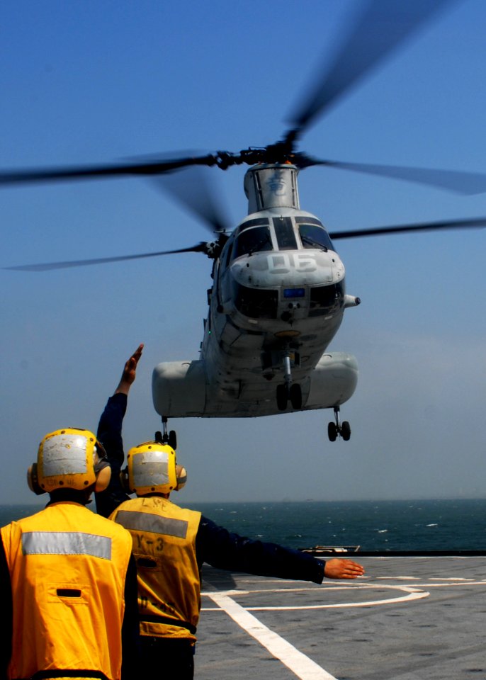 US Navy 091006-N-6692A-034 Sailors signal a Marine Corps CH-46 Sea Knight helicopter aboard the amphibious dock landing ship USS Tortuga (LSD 46)