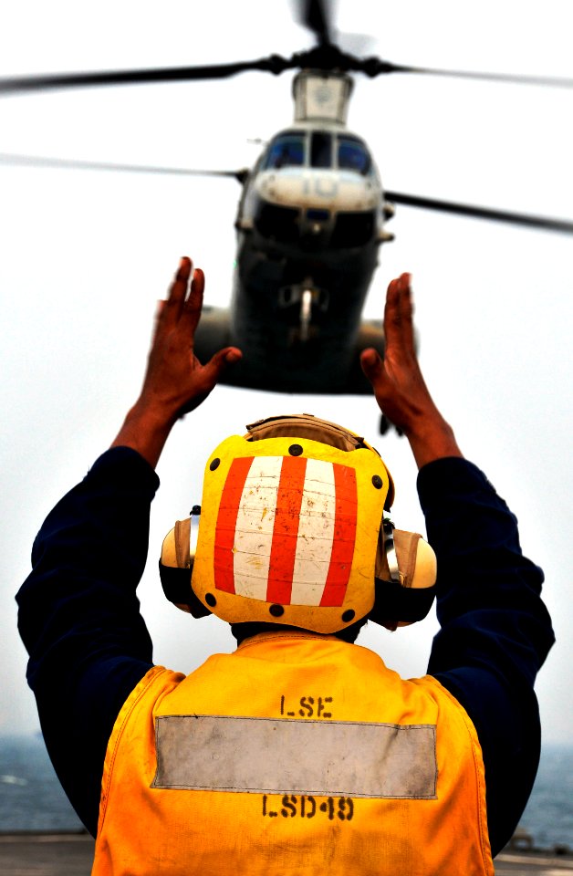 US Navy 091006-N-0807W-783 Boatswain's Mate 2nd Class Carigo A. Rula directs a Marine Corps CH-46 Sea Knight helicopter from the 31st Marine Expeditionary Unit (31st MEU) aboard the dock landing ship USS Harpers Ferry (LSD 49)