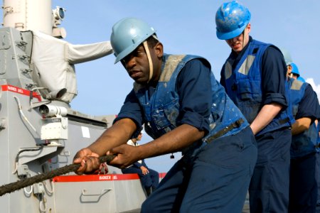 US Navy 091005-N-9123L-007 Sailors aboard the guided-missile destroyer USS McCampbell (DDG 85) heave around a line during a replenishment at sea photo