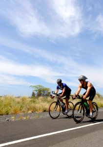 US Navy 091006-N-0555B-471 t. Cmdr. Don Cross, left, and Cmdr. David Haas train on the Kuakini Highway for the 2009 Ford Ironman World Championship
