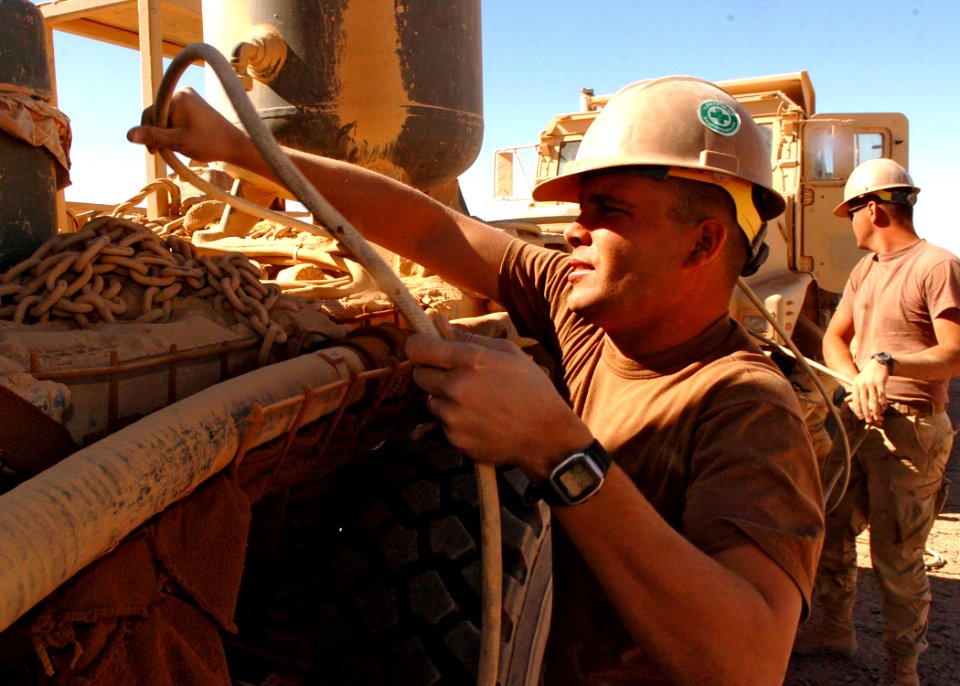 US Navy 091006-N-4440L-262 Construction Mechanic 2nd Class Paul Meagher, left, and Builder 2nd Class Robert Ishum, assigned to Naval Mobile Construction Battalion (NMCB) 74