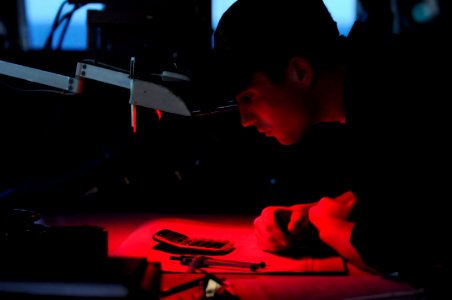 US Navy 091008-N-7478G-085 Quartermaster Seaman Jared Breland checks his calculations for moonrise aboard the amphibious command ship USS Blue Ridge (LCC 19)
