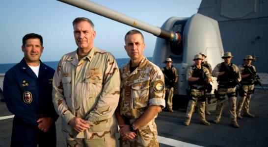 US Navy 091007-N-4154B-079 Capt. Frank Olmo, Rear Admiral Scott E. Sanders, Royal Navy Capt. Keith Blount along with members of Anzio's visit, board, search and seizure (VBSS) team and U.S. Coast Guard maritime safety and sec