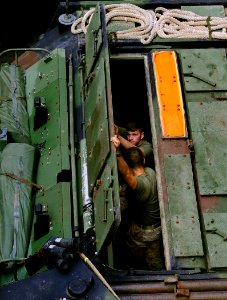 US Navy 091008-N-5345W-057 Marines assigned to the 22nd Marine Expeditionary Unit (22nd MEU) close the top hatch of their amphibious assault vehicle in the well deck of the amphibious dock landing ship USS Fort McHenry (LSD 43)