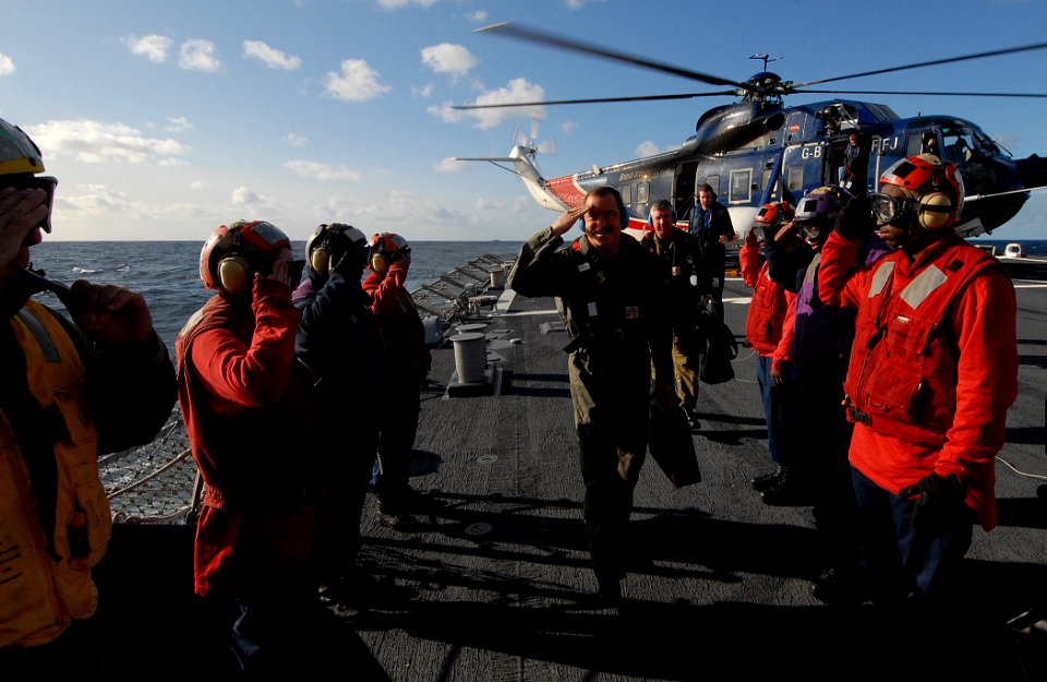 US Navy 091008-N-1688B-027 Side-boys aboard the guided missile destroyer USS Cole (DDG 67) salute as Rear Admiral Garry White, Commander, Strike Force Training Atlantic, boards the ship