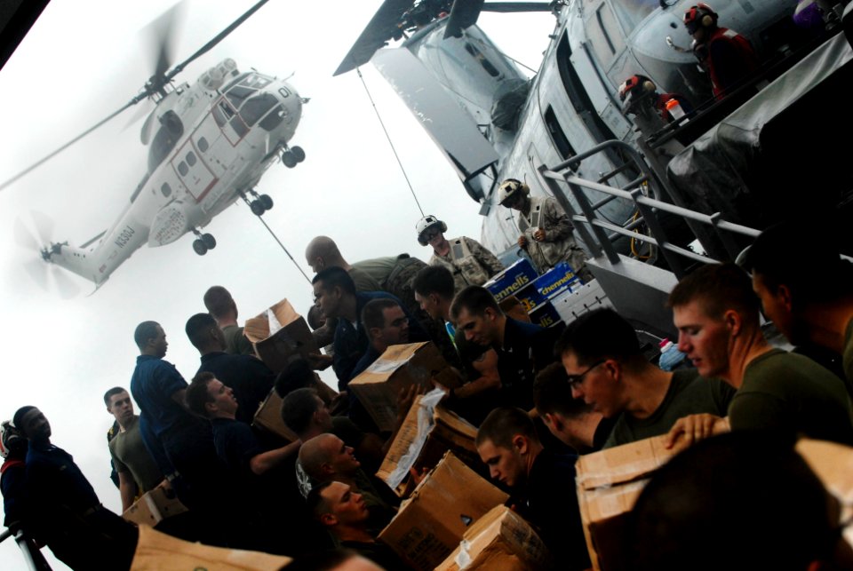 US Navy 091008-N-0807W-059 Sailors and Marines aboard the amphibious dock landing ship USS Harpers Ferry (LSD 49) pass stores during a vertical replenishment