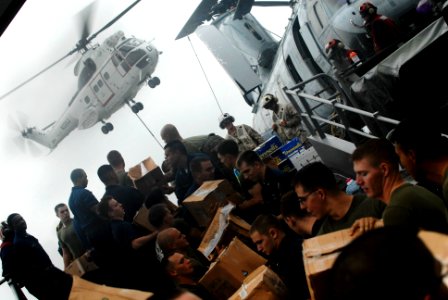 US Navy 091008-N-0807W-059 Sailors and Marines aboard the amphibious dock landing ship USS Harpers Ferry (LSD 49) pass stores during a vertical replenishment photo