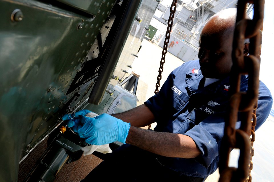 US Navy 091010-N-3830J-027 Aviation Structural Mechanic 2nd Class Jocelyn Joseph, assigned to Light Helicopter Antisubmarine Squadron (HSL) 51, performs maintenance on an SH-60F Sea Hawk helicopter