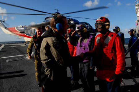US Navy 091008-N-1688B-038 Rear Admiral Garry White, Commander, Strike Force Training Atlantic, greets side-boys aboard the guided missile destroyer USS Cole (DDG 67) as he comes aboard
