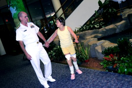 US Navy 091007-N-6220J-004 Rear Adm. Bill Goodwin, Assistant Chief of Naval Operations for the Next Generation Enterprise Network, tours Shriners Hospital for Children in Greenville with a young patient