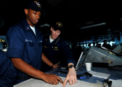 US Navy 091008-N-6233H-021 Lt. Cmdr. Chris Peyton Assistant Navigator assigned to the aircraft carrier USS George Washington (CVN 73) guides Quartermaster 3rd Class Alexander Davis in plotting a safe navigation course