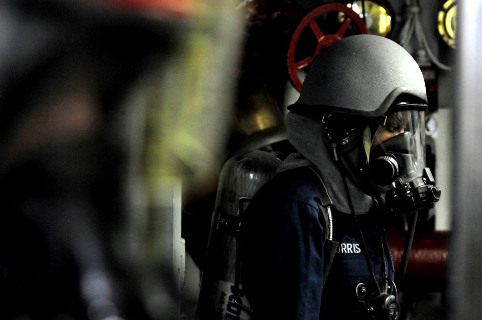 US Navy 091008-N-7280V-111 Machinist's Mate 3rd Class Cloreshia Morris stands by as the aqueous film forming foam operator during a major fuel oil leak drill aboard amphibious command ship USS Blue Ridge (LCC 19)