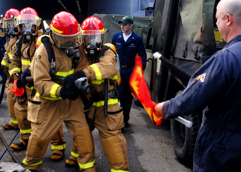 US Navy 091010-N-6692A-008 The rapid response Flying Squad Team fight a simulated class bravo fire during damage control training