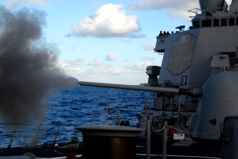 US Navy 091008-N-1688B-302 Smoke flares from the barrel of the 5 inch gun aboard the guided missile destroyer USS Cole (DDG 67) during a live fire exercise
