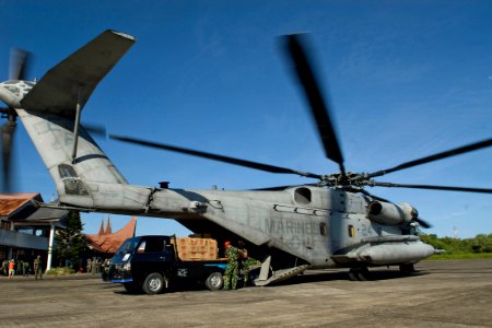 US Navy 091009-N-9123L-046 U.S. Marine and Indonesian Air Force personnel prepare to load a CH-53E Super Stallion helicopter from the Dragons of Marine Medium Helicopter Squadron (HMM) 265 with relief supplies photo