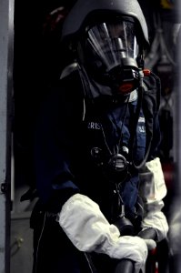 US Navy 091008-N-7280V-112 Machinist's Mate 3rd Class Cloreshia Morris mans the aqueous film forming foam hose during a major fuel oil leak drill aboard amphibious command ship USS Blue Ridge (LCC 19) photo