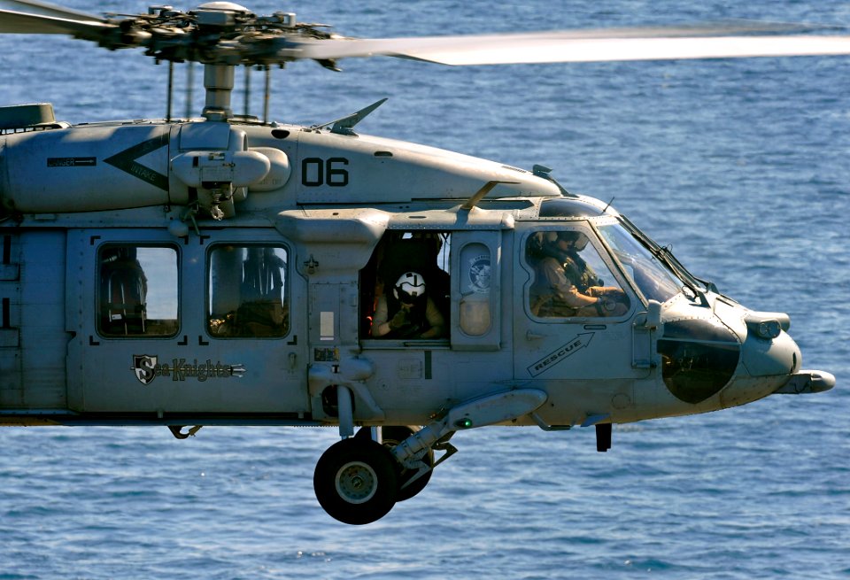 US Navy 091012-N-5345W-267 An air crew member keeps a look out as an MH-60S Sea Hawk helicopter assigned to the Sea Knights of Helicopter Sea Combat Squadron (HSC) 22 lifts off from the amphibious dock landing ship USS Fort McH