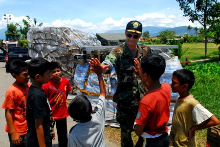 US Navy 091010-N-9123L-026 Commander, Amphibious Force Seventh Fleet, Rear Adm. Richard Landolt meets with some children outside the Humanitarian Assistance Rapid Response Team medical tent in Padang, Indonesia
