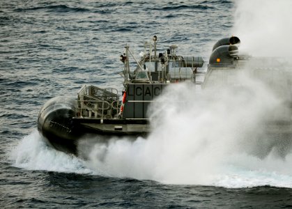 US Navy 091010-N-5345W-338 A landing craft, air cushion (LCAC) assigned to Assault Craft Unit (ACU) 4 exits the well deck of the amphibious dock landing ship USS Fort McHenry (LSD 43) photo