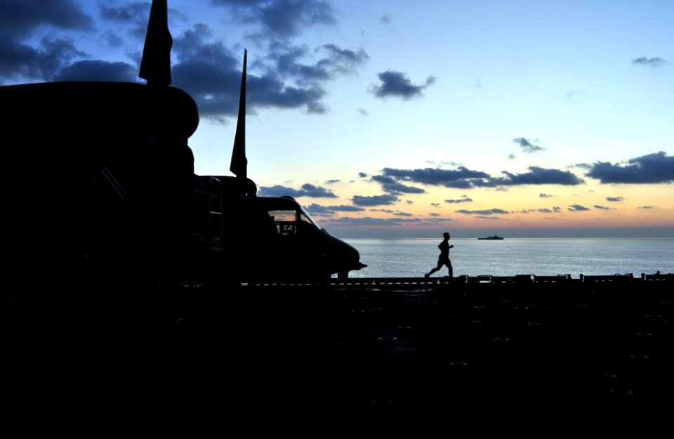 US Navy 091011-N-9740S-044 A Marine assigned to the 22nd Marine Expeditionary Unit (22nd MEU) jogs on the flight deck of the multi-purpose amphibious assault ship USS Bataan (LHD 5) during Exercise Bright Star 2009