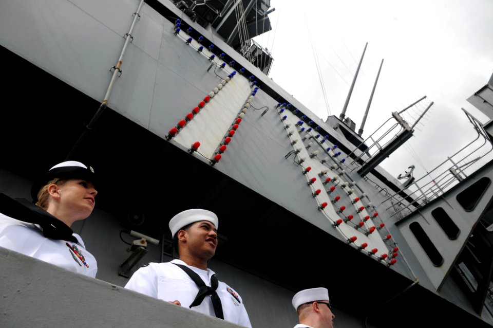 US Navy 091013-N-3610L-202 Sailors assigned to the aircraft carrier USS Ronald Reagan man the rails as the ship passes by the USS Arizona Memorial in Pearl Harbor