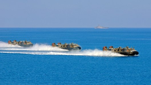 US Navy 091012-N-1831S-153 Three landing craft, air cushion vehicles approach the shore after launching from the multi-purpose amphibious assault ship USS Bataan (LHD 5) during Bright Star 2009