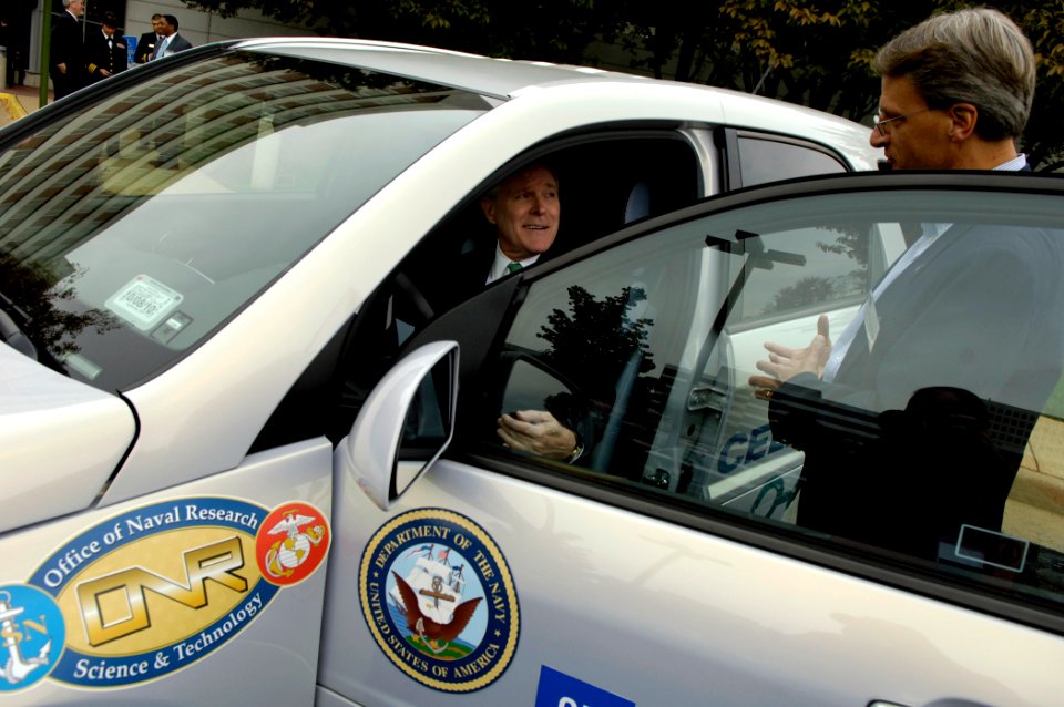 US Navy 091014-N-7676W-480 Gary Stottler, right, from General Motors Corp., gives the Secretary of the Navy (SECNAV) the Honorable Ray Maybus an overview of a Office of Naval Research-sponsored fuel cell vehicle