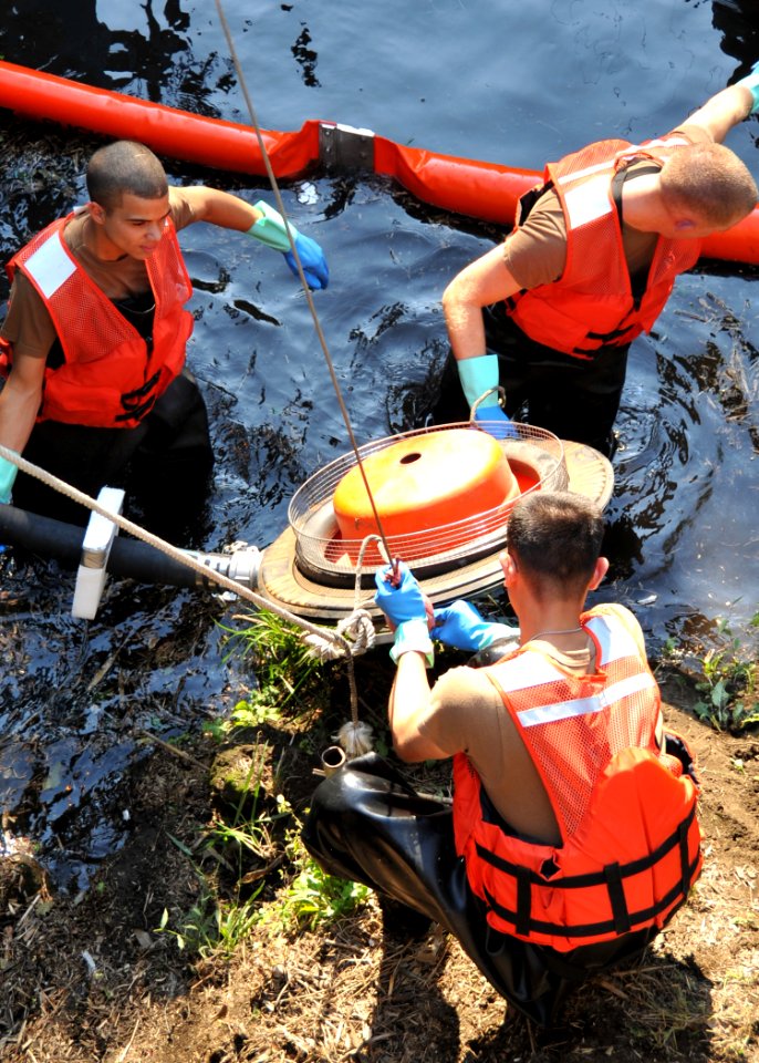US Navy 091013-N-4031K-051 Sailors assigned to the Public Works Department Construction Battalion of Naval Air Facility Atsugi, Japan, prepare an oil collection machine to suction oil into a spill truck