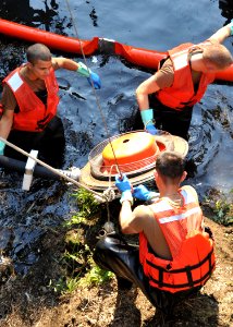 US Navy 091013-N-4031K-051 Sailors assigned to the Public Works Department Construction Battalion of Naval Air Facility Atsugi, Japan, prepare an oil collection machine to suction oil into a spill truck
