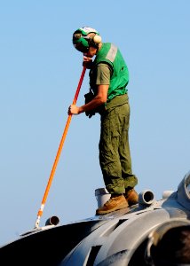 US Navy 091015-N-5214S-061 A Marine assigned to Marine Medium Tiltrotor Squadron (VMM) 263 (Reinforced), 22nd Marine Expeditionary Unit (22nd MEU), washes an AV-8B Harrier aboard amphibious assault ship USS Bataan (LHD 5)