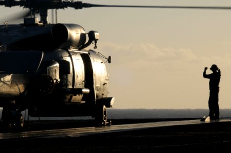 US Navy 091012-N-9132C-128 A Sailor communicates with the pilots of an SH-60B Sea Hawk helicopter assigned to the Battle Cats of Light Helicopter Anti-Submarine Squadron (HSL) 43 aboard the aircraft carrier USS Ronald Reagan (C